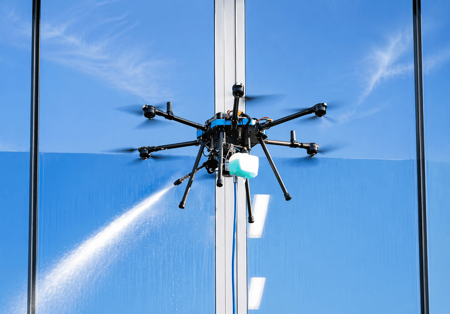 Sherpa drone cleaning a glass facade against blue sky